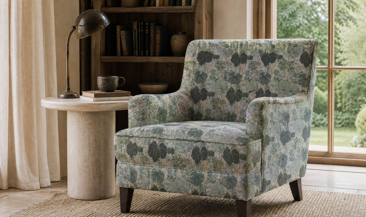 Foliage Leaf botanical upholstery fabric in soft green and blue on a statement armchair