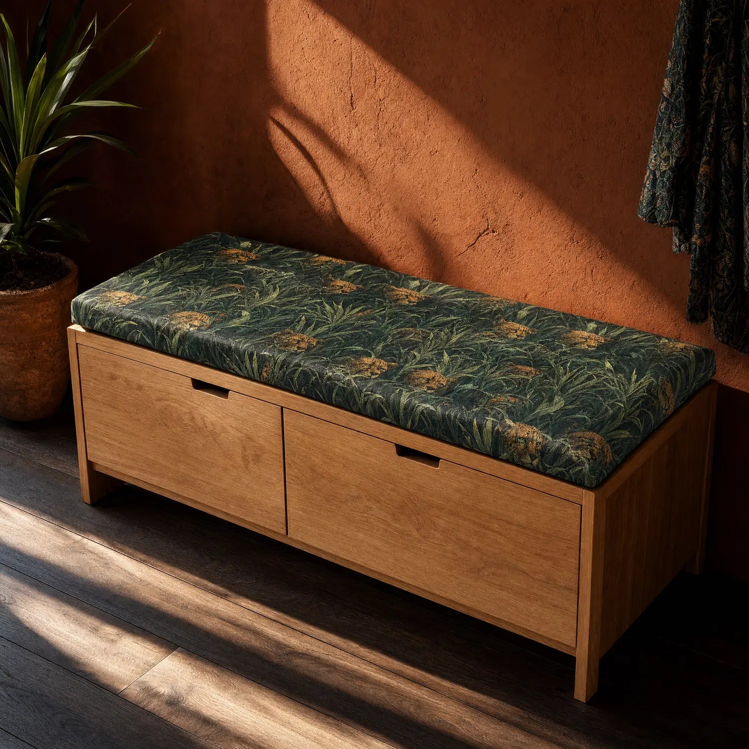 Animal print upholstery fabric featuring hidden jungle cats and layered tropical foliage in deep green and earthy olive tones on upholstered storage bench