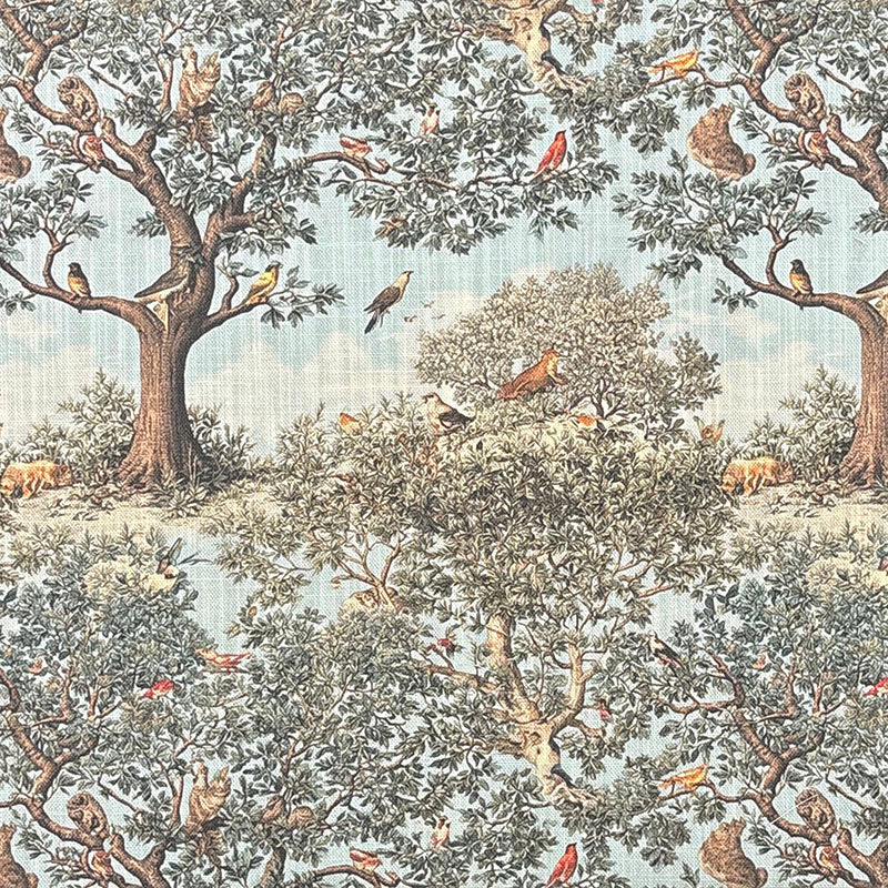 Traditional style upholstery fabric featuring woodland birds, mature trees, wildlife and botanical scenery on a soft blue background