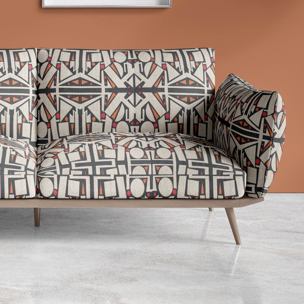 Contemporary armchair upholstered in Avant No.15 geometric fabric with bold black lines and circular forms