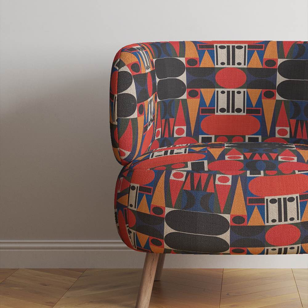 Modern armchair upholstered in Avant No.9 cubist fabric in structured colour-blocked shapes