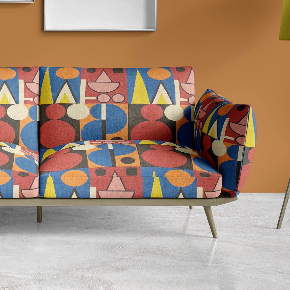 Upholstered sofa in Avignon No.9 fabric – geometric designer textile in vibrant colour palette