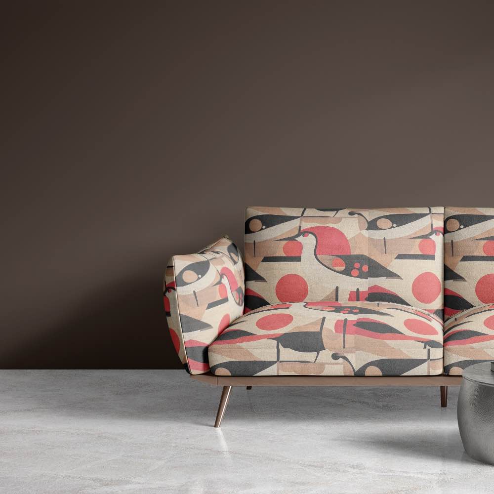 Two-seater sofa upholstered in Bird No.10 fabric against a taupe wall