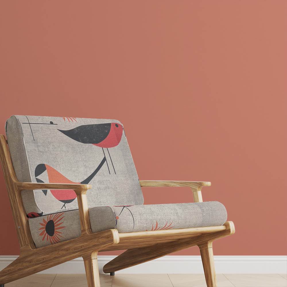 Armchair upholstered in Bird No.19 burnt orange and cream bird fabric