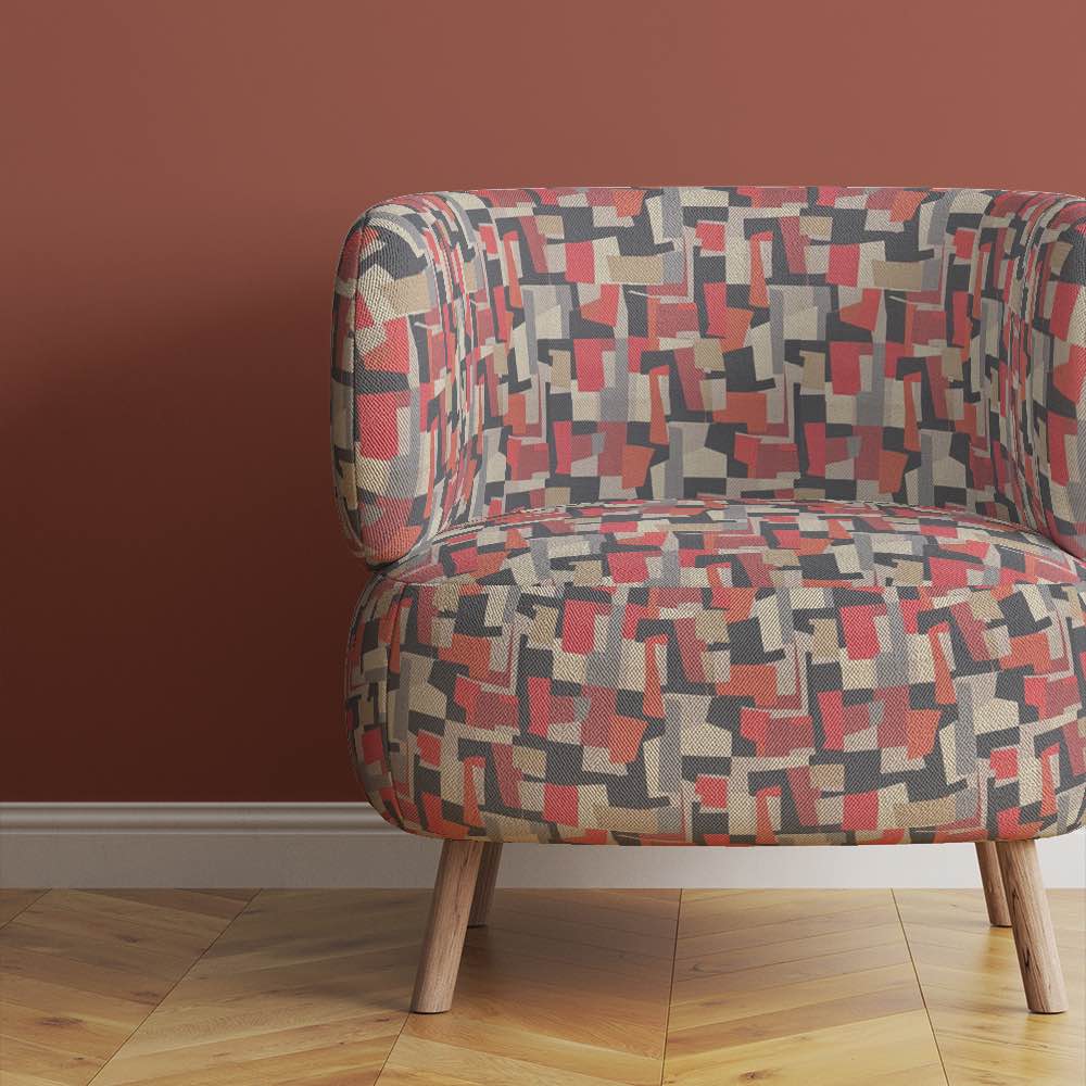 accent-chair-upholstered-in-collage-no-2-abstract-fabric-with-earth-tone-rectangles-in-a-modern-room
