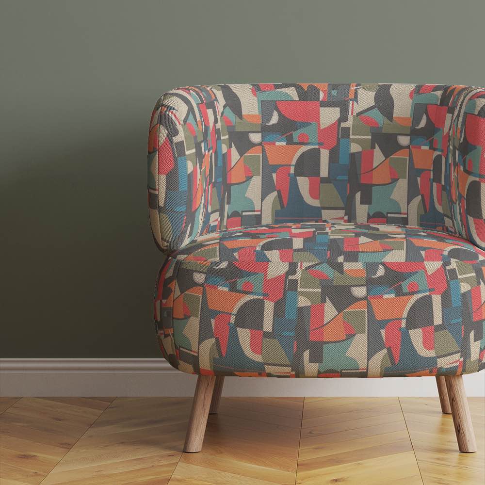 modern-armchair-upholstered-in-collage-no-7-fabric-displaying-bold-retro-inspired-blocks-in-muted-and-saturated-tones