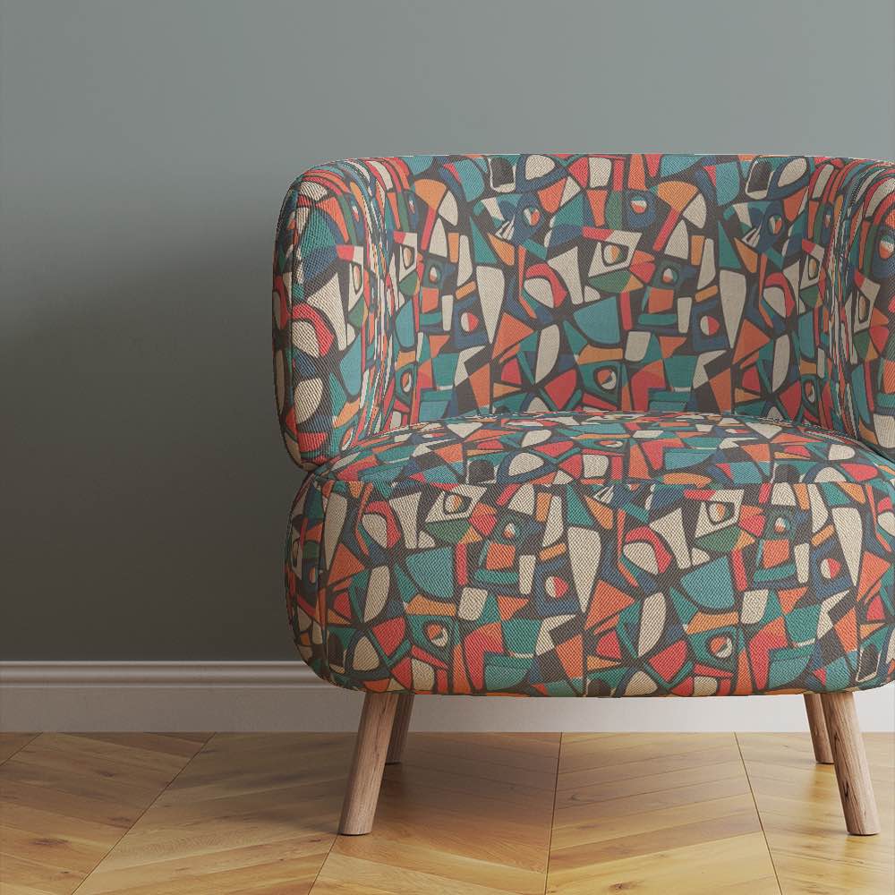 armchair-upholstered-in-collage-no-9-fabric-against-muted-grey-wall-highlighting-modernist-pattern-and-colour-depth