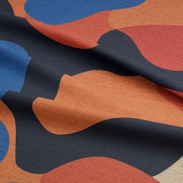 folded-detail-of-creation-no-1-upholstery-fabric-featuring-colour-blocked-biomorphic-shapes-in-rust-navy-and-cream-tones
