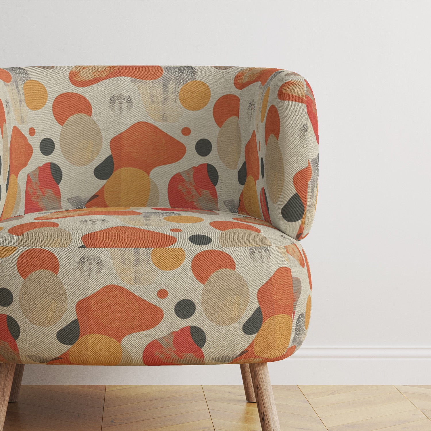 modern-armchair-upholstered-in-creation-no-2-fabric-against-dark-grey-wall-with-natural-wood-flooring