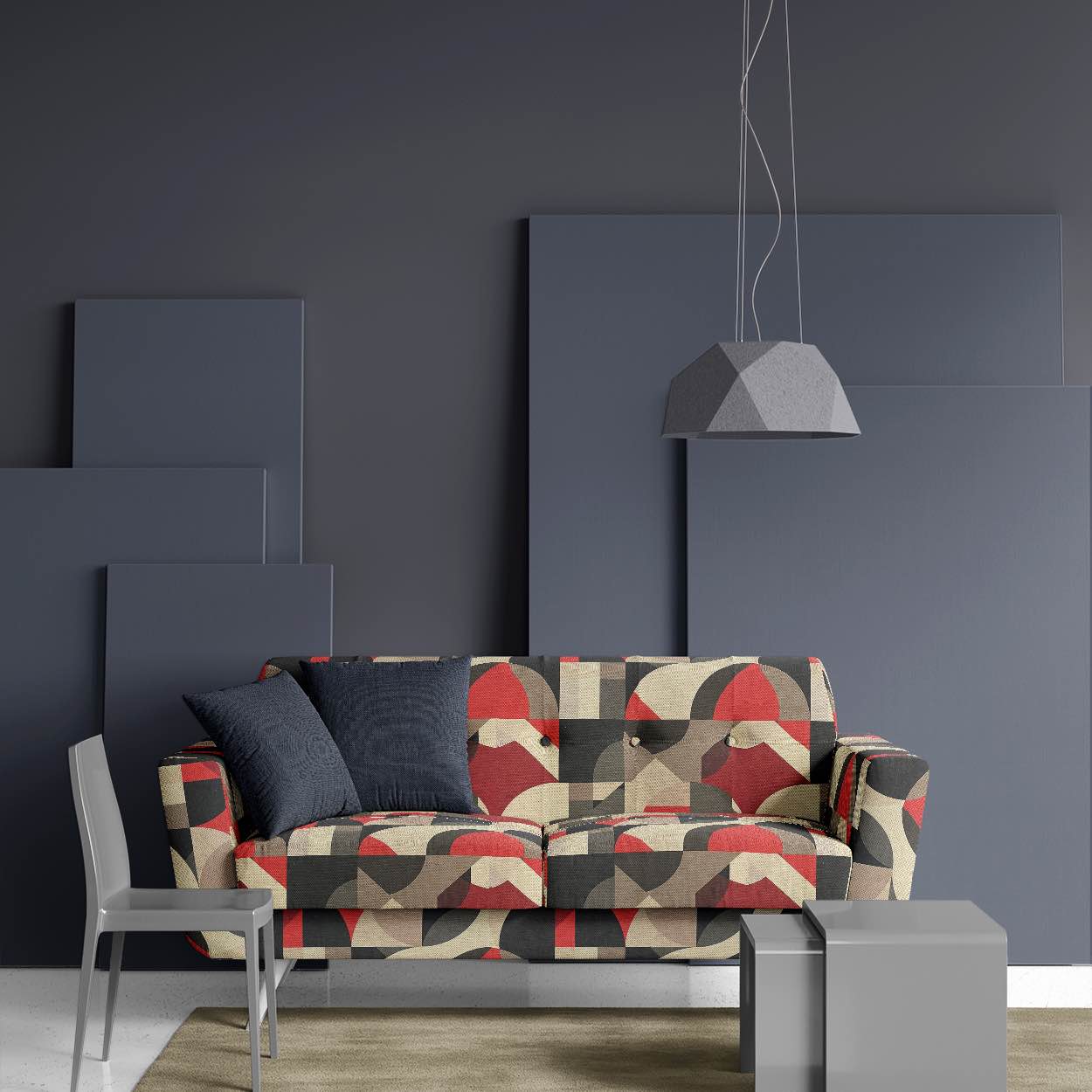 Modern sofa upholstered in sculptural geometric fabric with bold red, grey, and beige tones against a dark interior setting