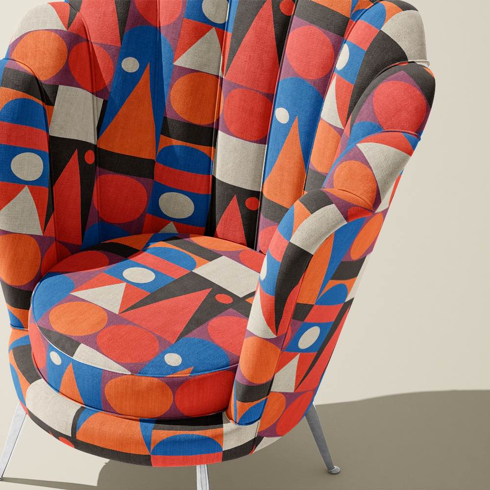 Curved accent chair upholstered in Cubism No.14 fabric, placed in a modern minimalist setting