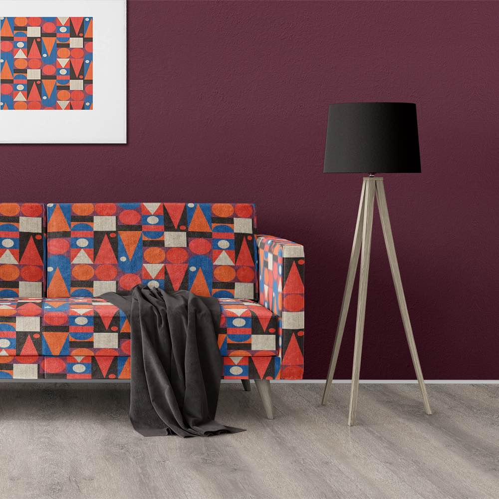 Modern sofa upholstered in Cubism No.16 with bold red, orange, and blue graphic design