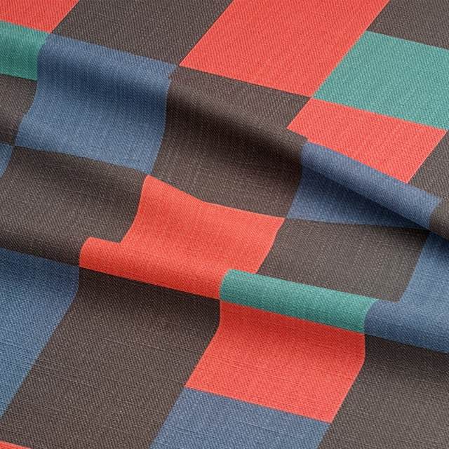Close-up of Cubism No.20 upholstery fabric showing crisp block shapes and vivid colour contrast in luxury woven material