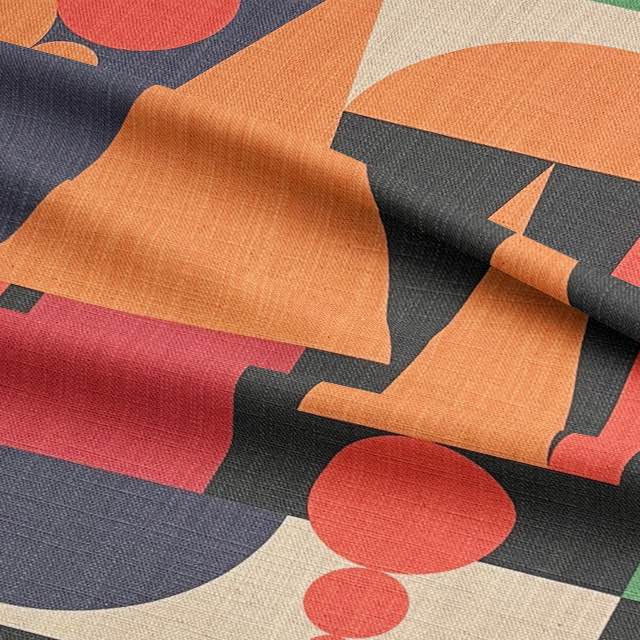 Close-up of Cubism No.3 luxury upholstery fabric showing rich orange and black shapes on a neutral woven base