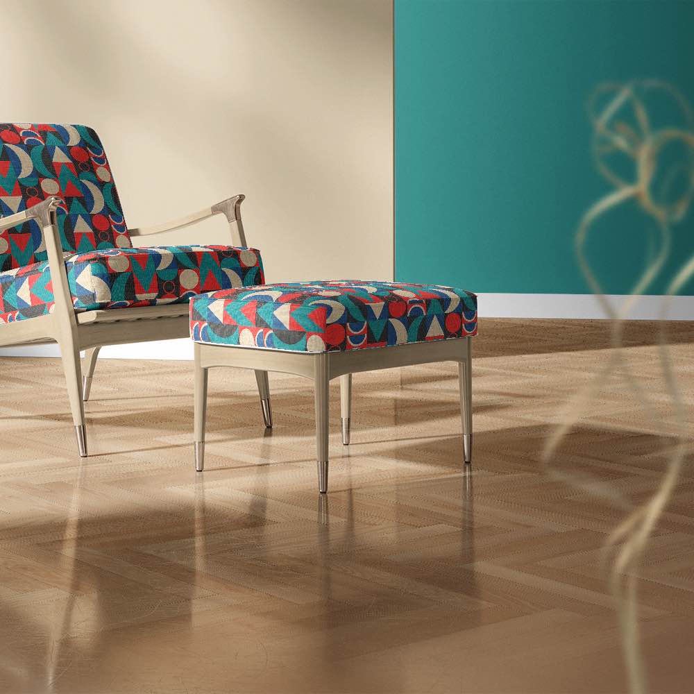 Pair of modern armchairs upholstered in Cubism No.4 fabric, styled with teal feature wall and herringbone wood flooring