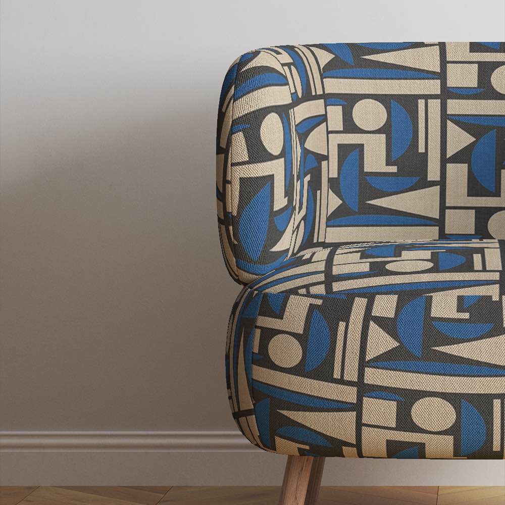 Mid-century style armchair upholstered in Cubism No.7, styled in a minimalist room with neutral tones