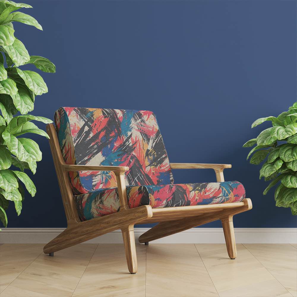 Upholstered armchair in Dash No.4 luxury brushstroke fabric – red and blue abstract design in modern living room setting with navy wall and wood flooring
