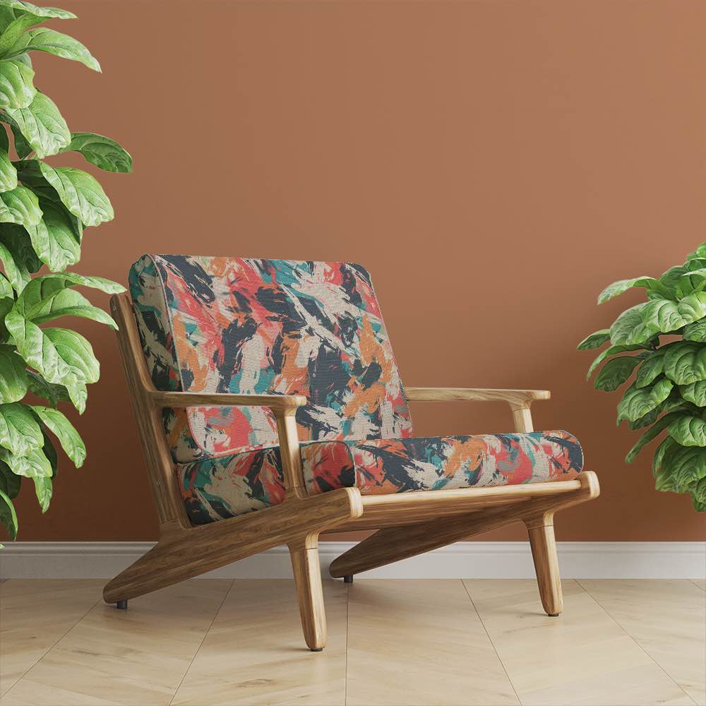 Modern armchair upholstered in Dash No.7 fabric, styled in warm terracotta interior with plants