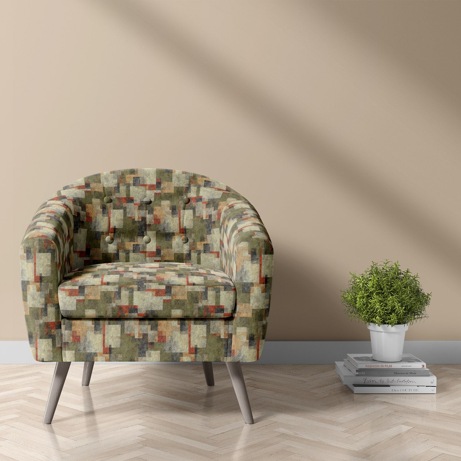 Armchair upholstered in Dessau No.17 green abstract upholstery fabric, styled in a modern room with taupe wall and wood flooring.