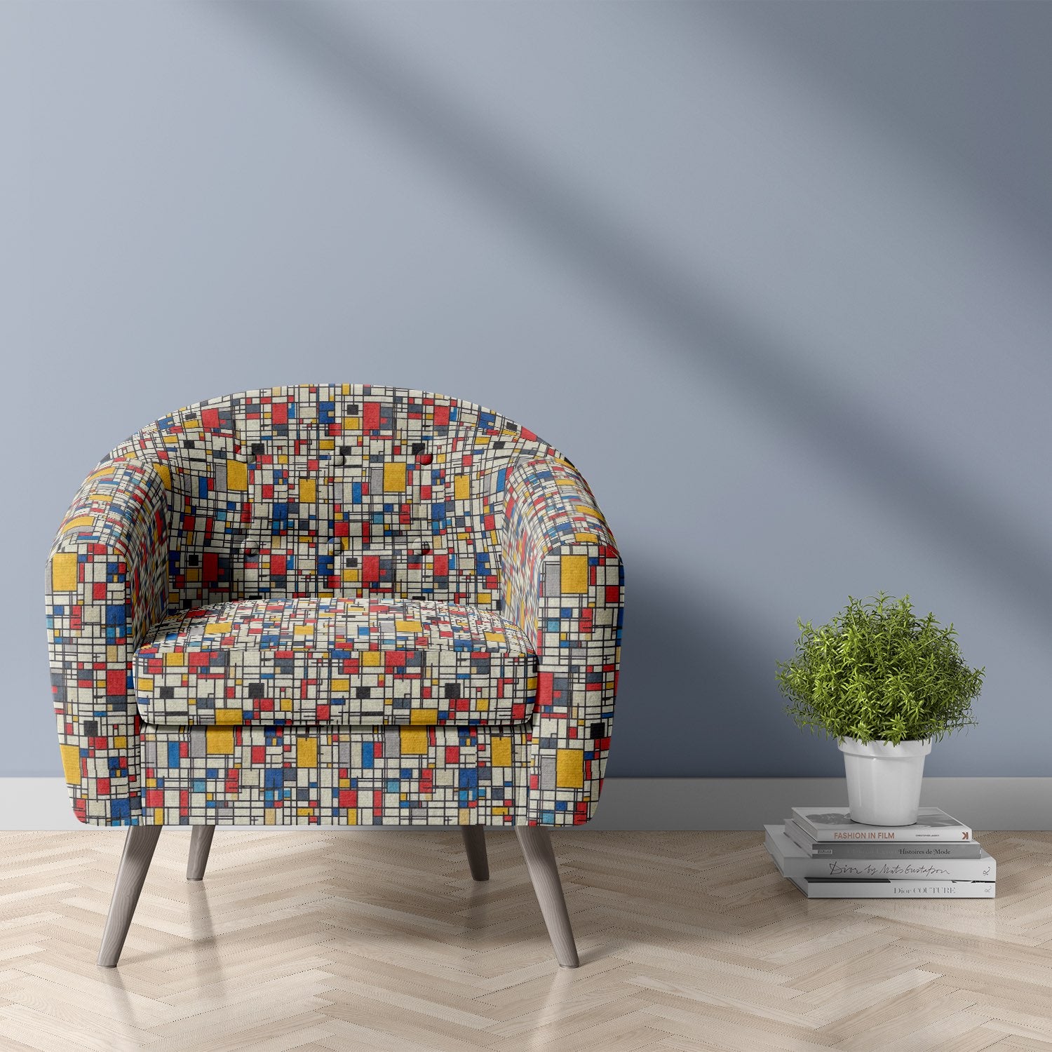 Armchair upholstered in Dessau No.22 multicoloured upholstery fabric with Bauhaus-inspired geometric pattern