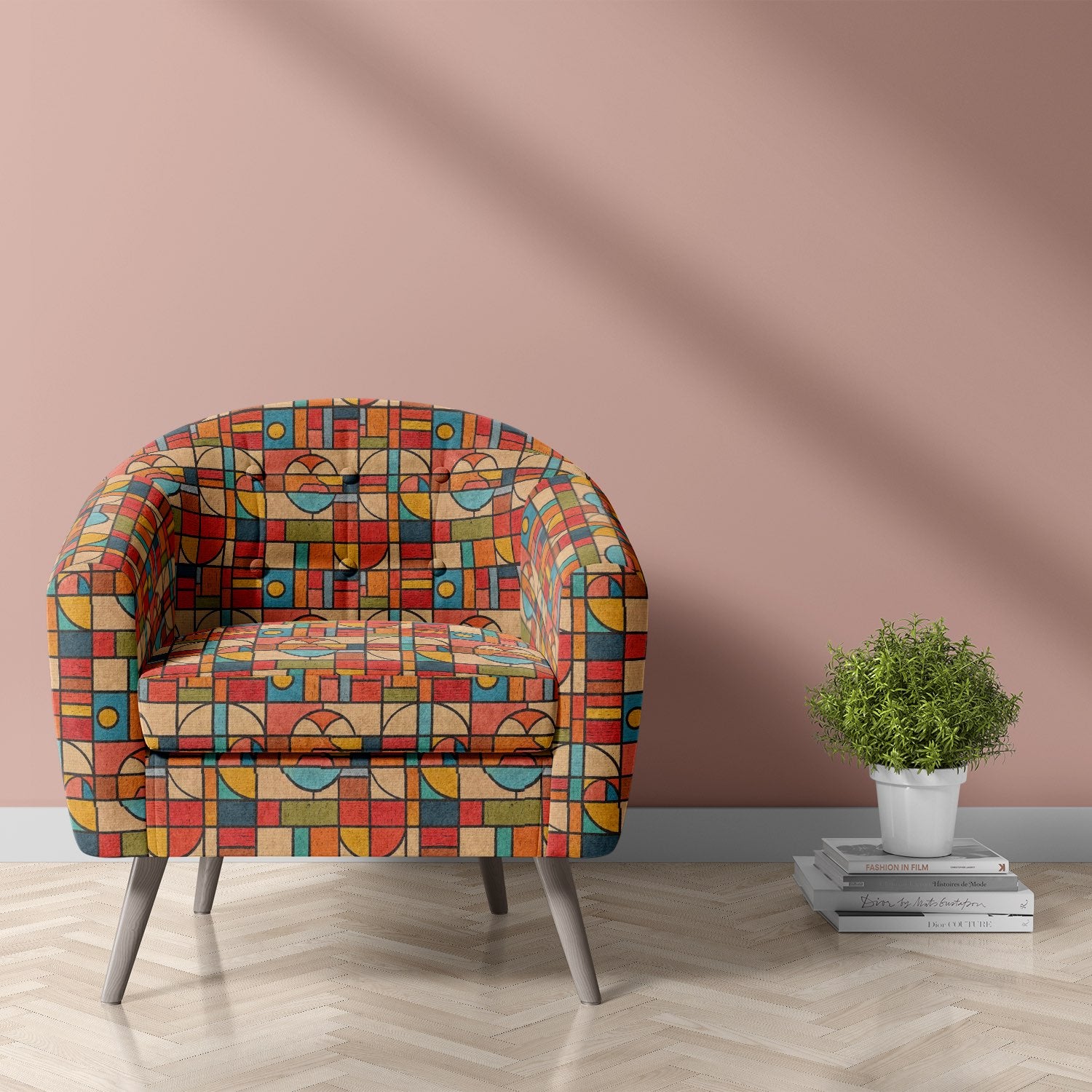 Statement upholstery fabric armchair with Bauhaus-inspired geometric design combining curved shapes and multicoloured blocks in warm tones