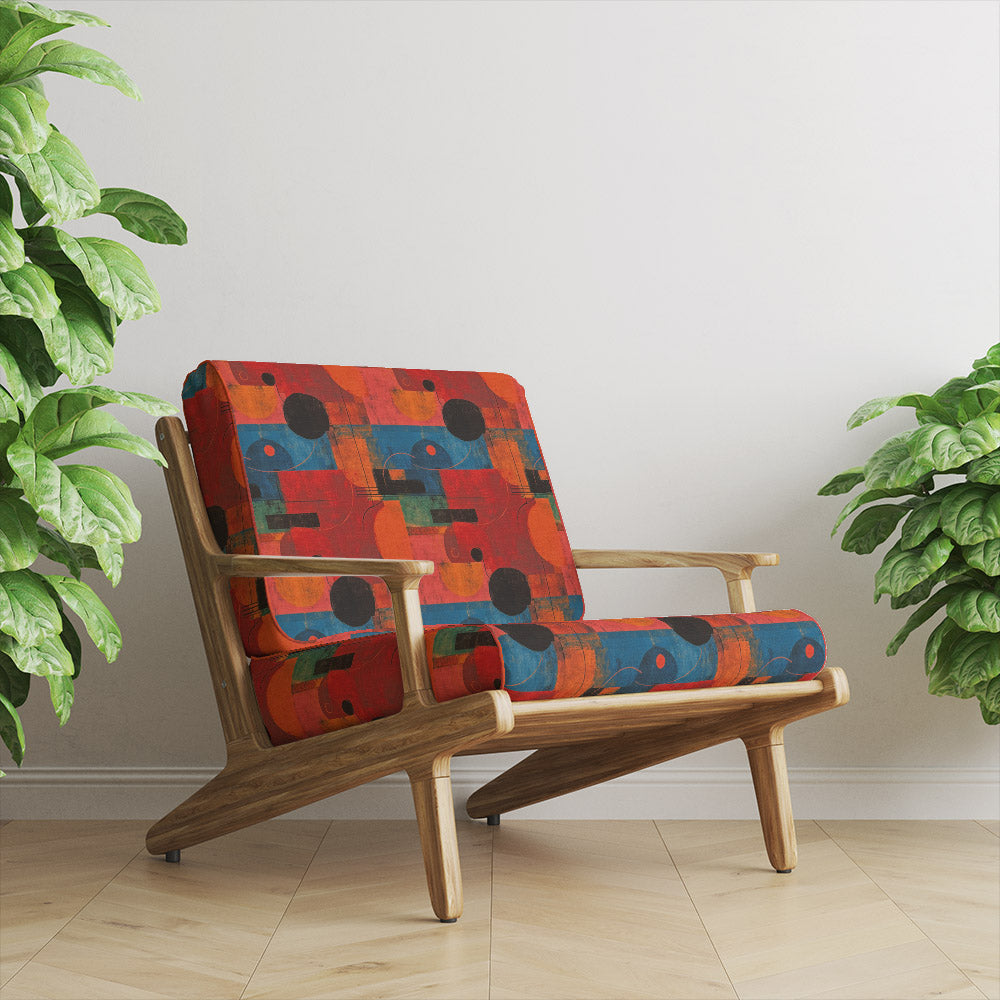 Mid-century chair upholstered in Dessau No.9 multicoloured upholstery fabric with bold cubist pattern