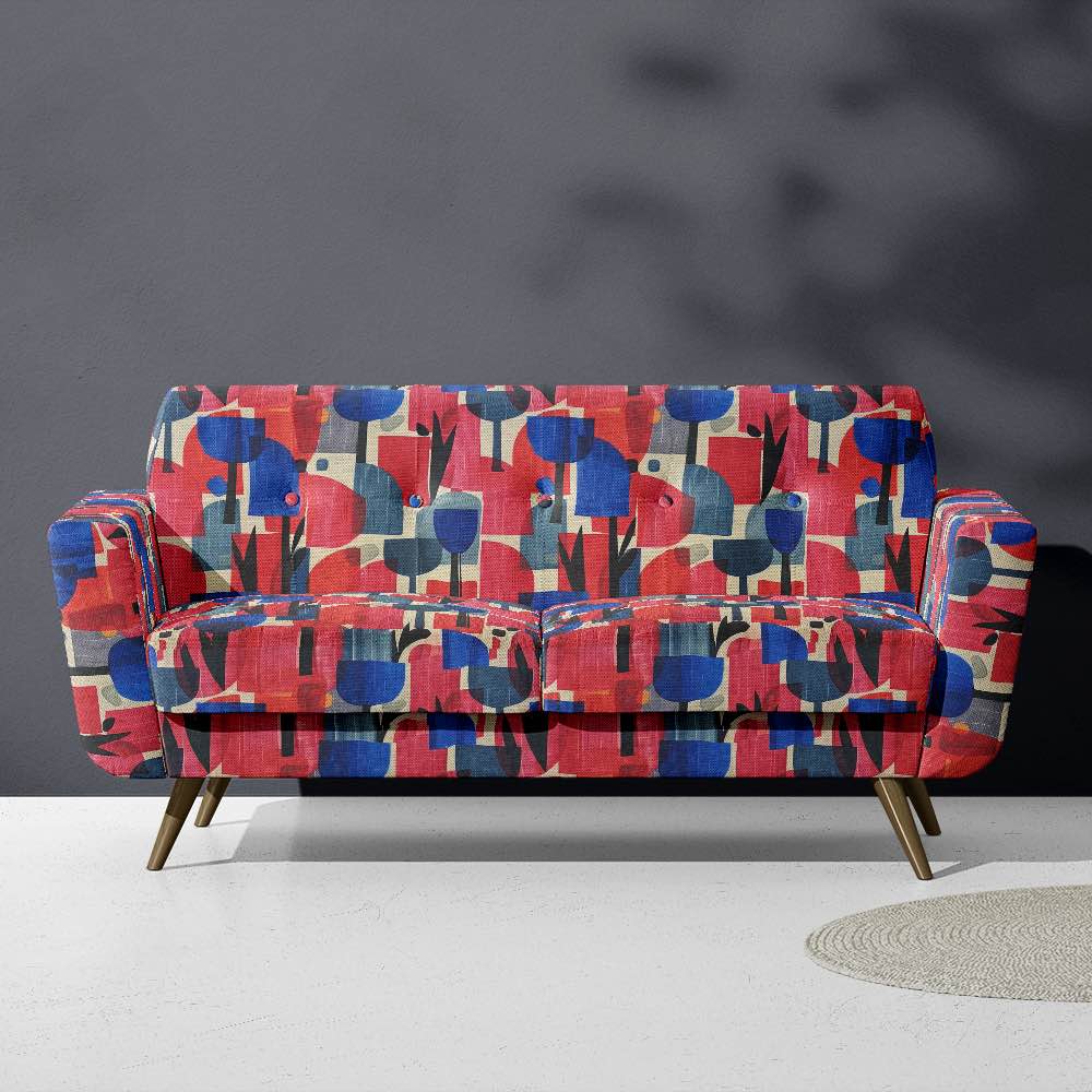 Modern sofa upholstered in Dimension No.3 contemporary floral fabric in red and navy