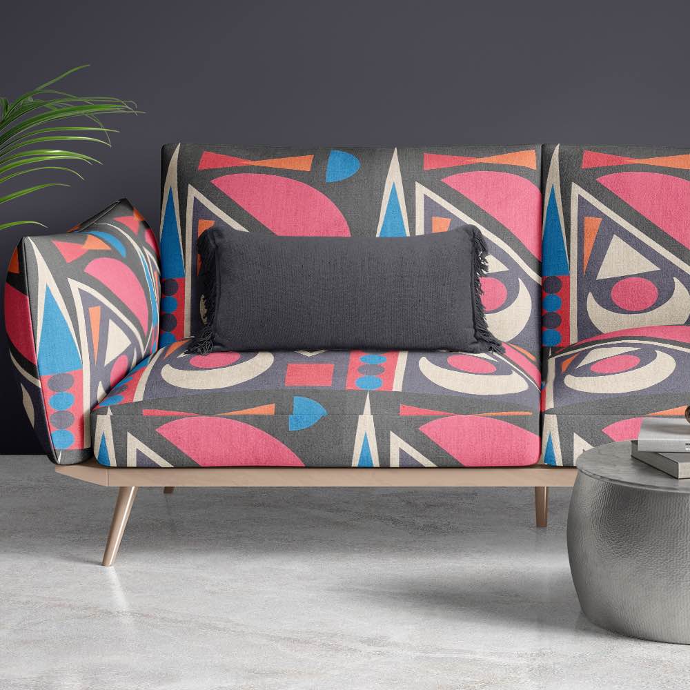 Modern sofa upholstered in Estaque No.15 featuring abstract graphic textile design in bold colours