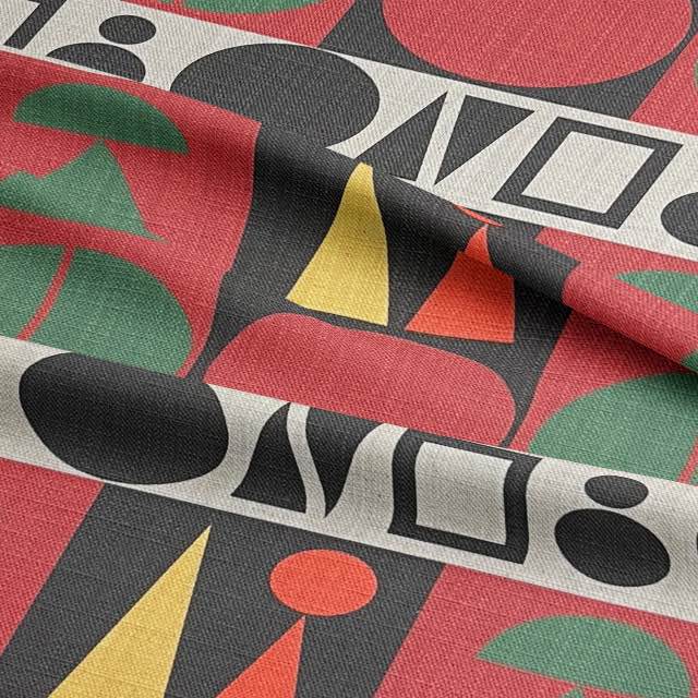 Close-up texture of Estaque No.8 upholstery fabric showing rich red and green cubist design on natural linen base