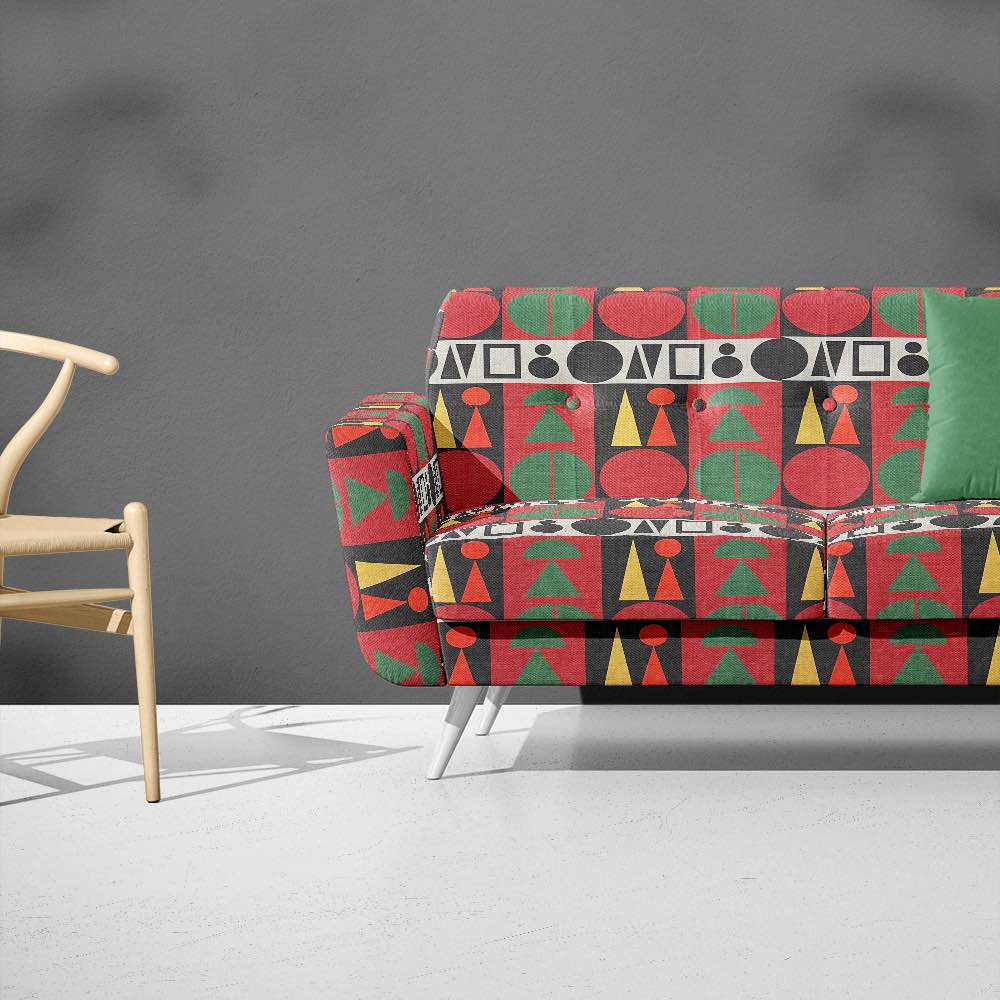 Bold patterned sofa upholstered in Estaque No.8 fabric featuring graphic shapes in multicolour palette