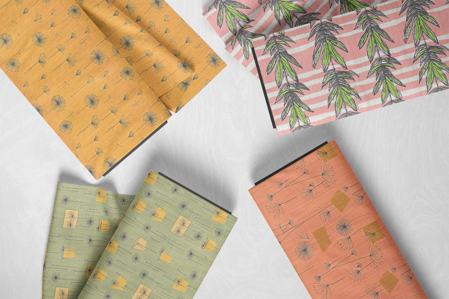 Flat lay of digitally printed upholstery fabrics in hand-drawn designs, showing precision and colour depth not achievable with woven methods