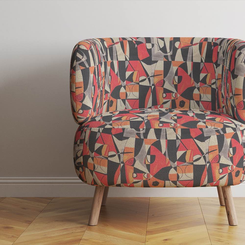 Upholstered armchair in Exhibite No.13 fabric, styled in a minimalist room with wooden flooring
