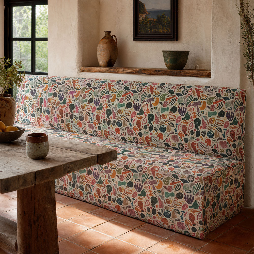 Fauve No.21 light multicoloured abstract upholstery fabric on a bench in a calm contemporary interior