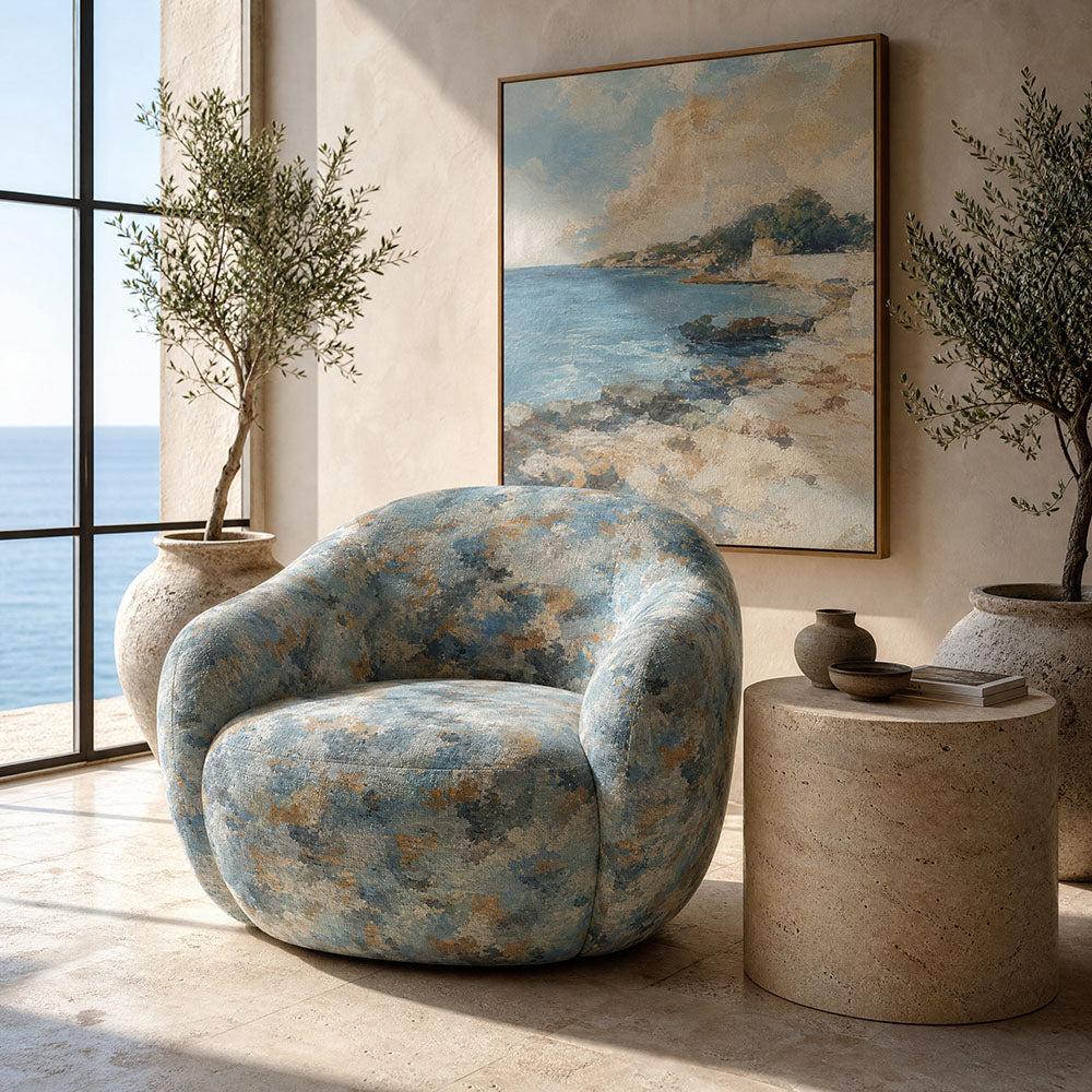 Fauve No.4 blue and orange abstract upholstery fabric on a rounded statement chair in a soft contemporary room