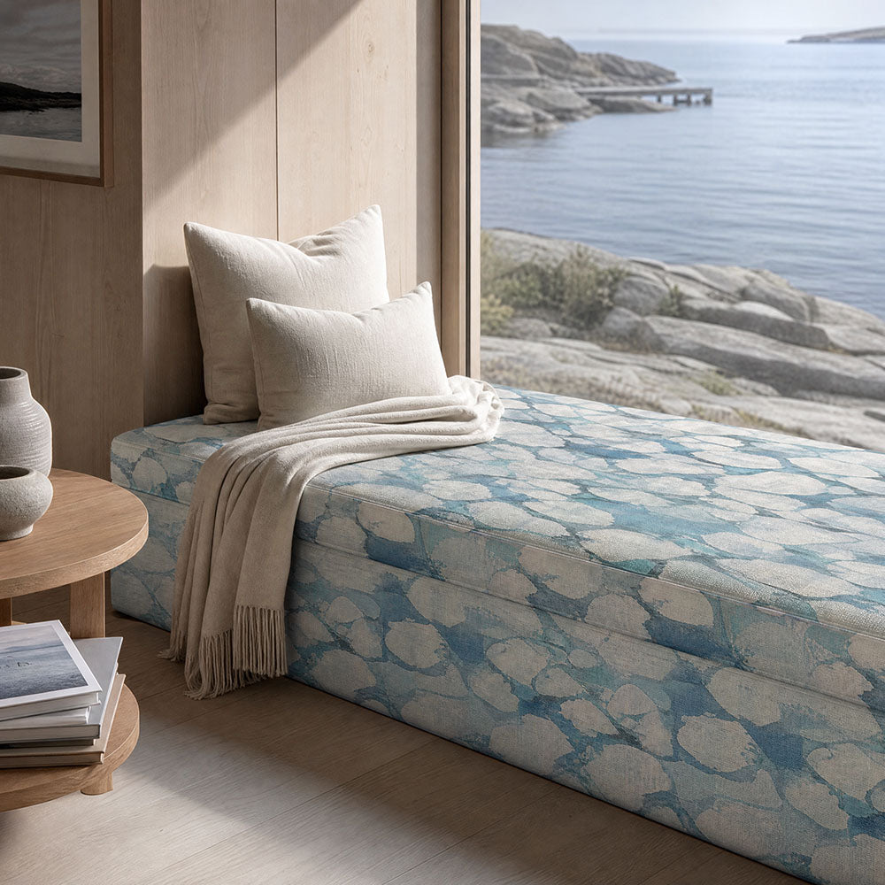 Fauve No.5 blue abstract upholstery fabric on an upholstered bench in a calm neutral interior