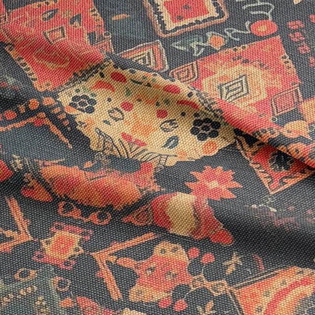 Fiery orange and charcoal upholstery fabric with tribal motifs and textured weave
