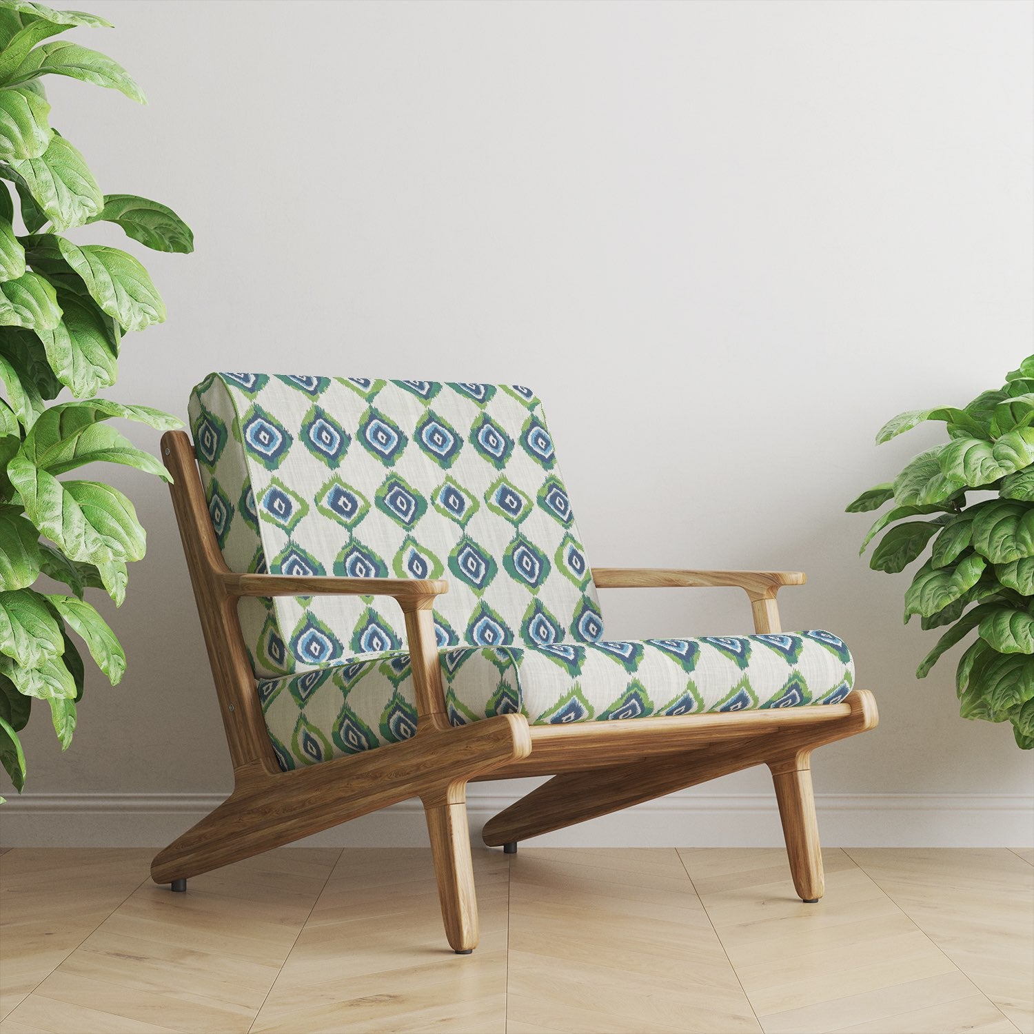 Mid-century armchair upholstered in Kilim No.23 upholstery fabric with geometric tribal diamonds in navy, green, and blue