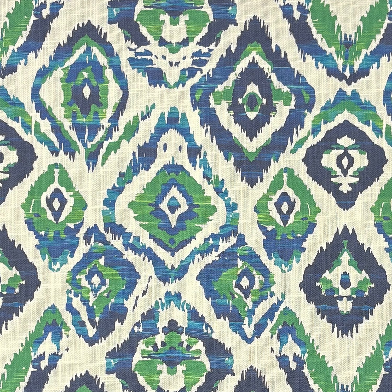 Flat image of Kilim No.24 upholstery fabric featuring painterly diamond ikat motifs in blue and green on a natural background