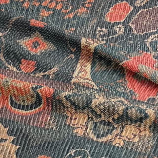 Detail of faded kilim upholstery fabric featuring floral and geometric medallions