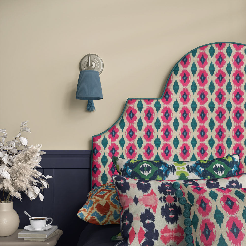 Armchair upholstered in Kilim No.35 Crib5 velvet with pink and teal Kilim design in a modern room setting