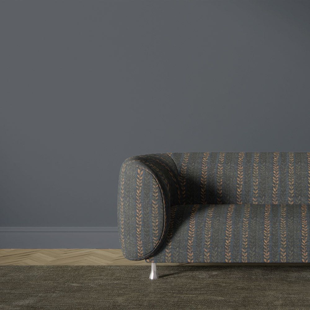 Lovverk Stripe No.2 dark blue botanical striped upholstery fabric on a curved sofa