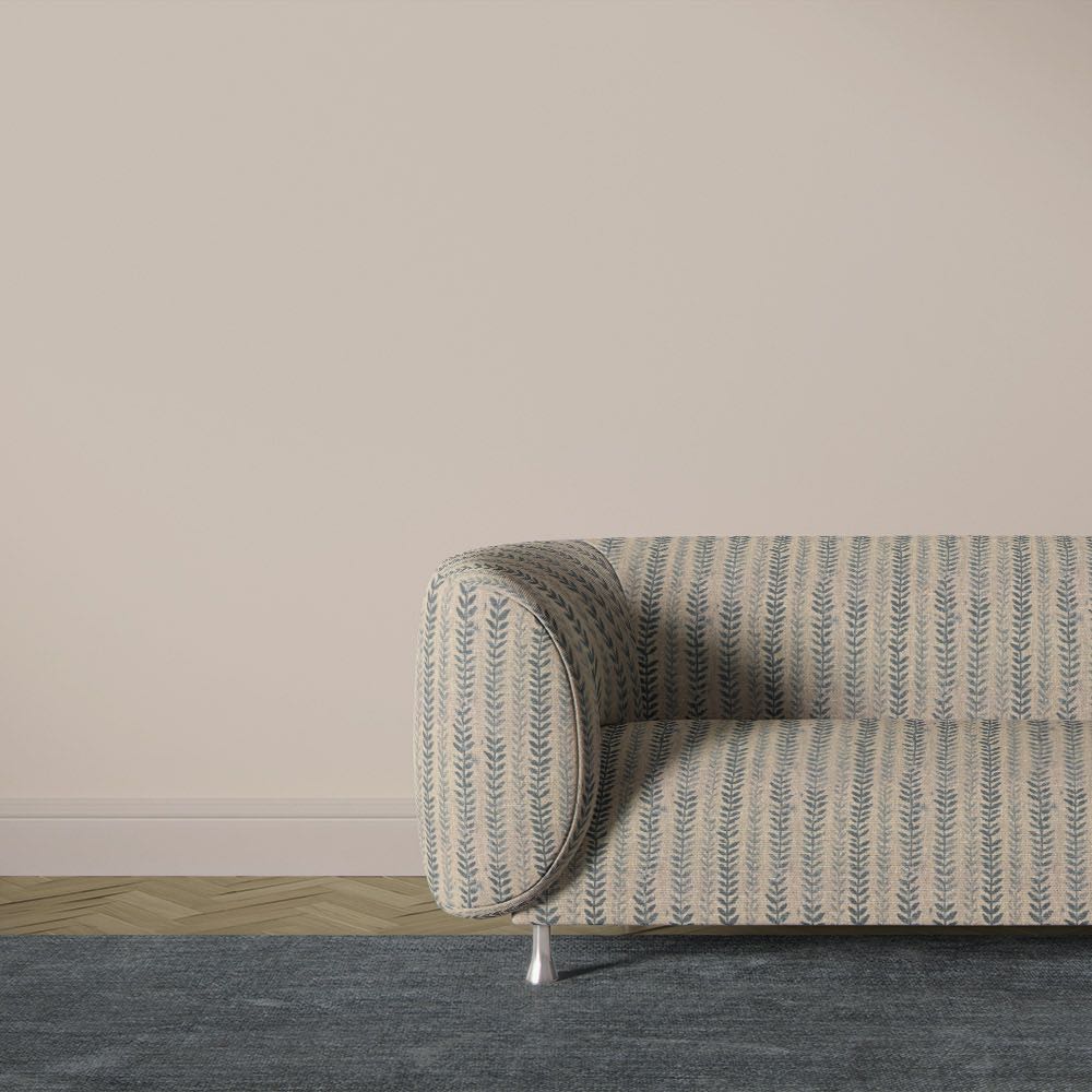 Lovverk Stripe No.4 natural sage botanical striped upholstery fabric on a curved sofa