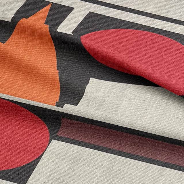 Close-up of abstract upholstery fabric with minimalist red and ivory design