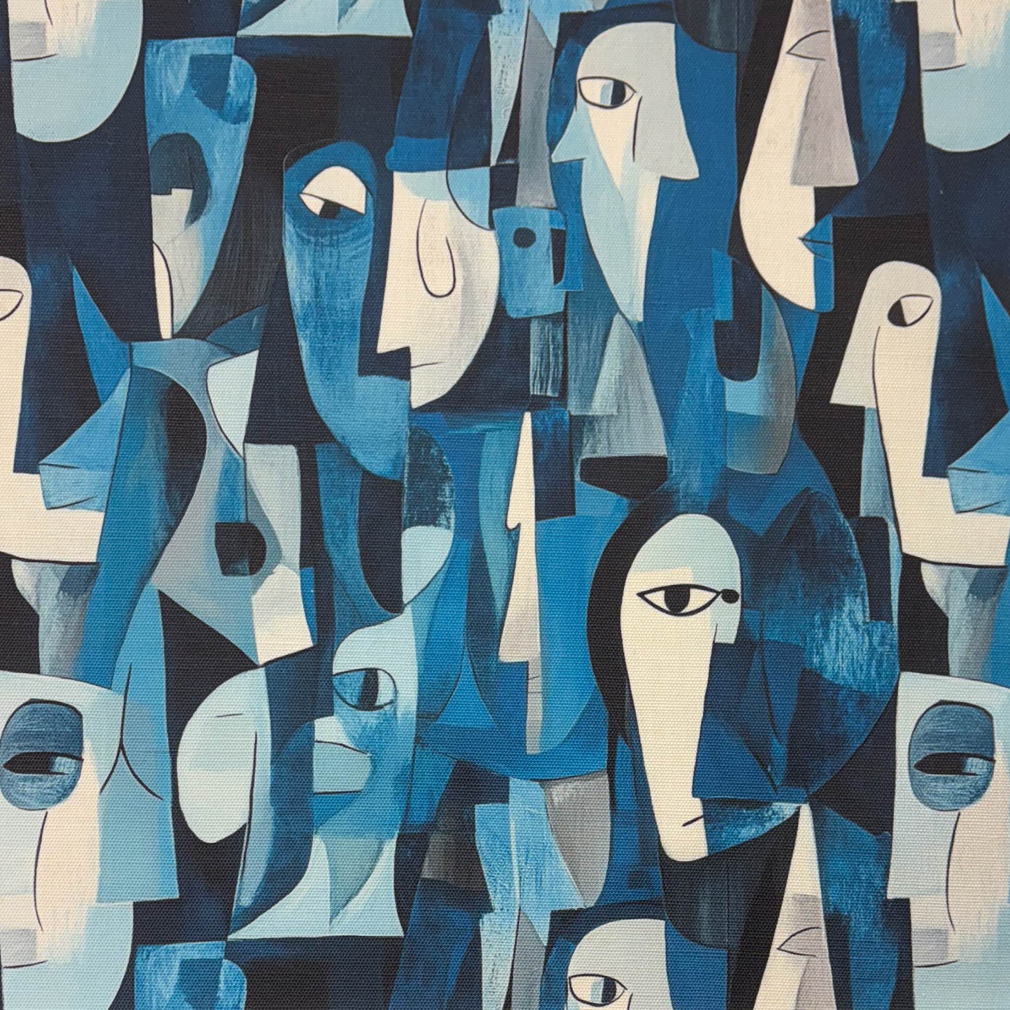 Flat lay of Mougin No.15 Upholstery Fabric with tonal blue abstract face design