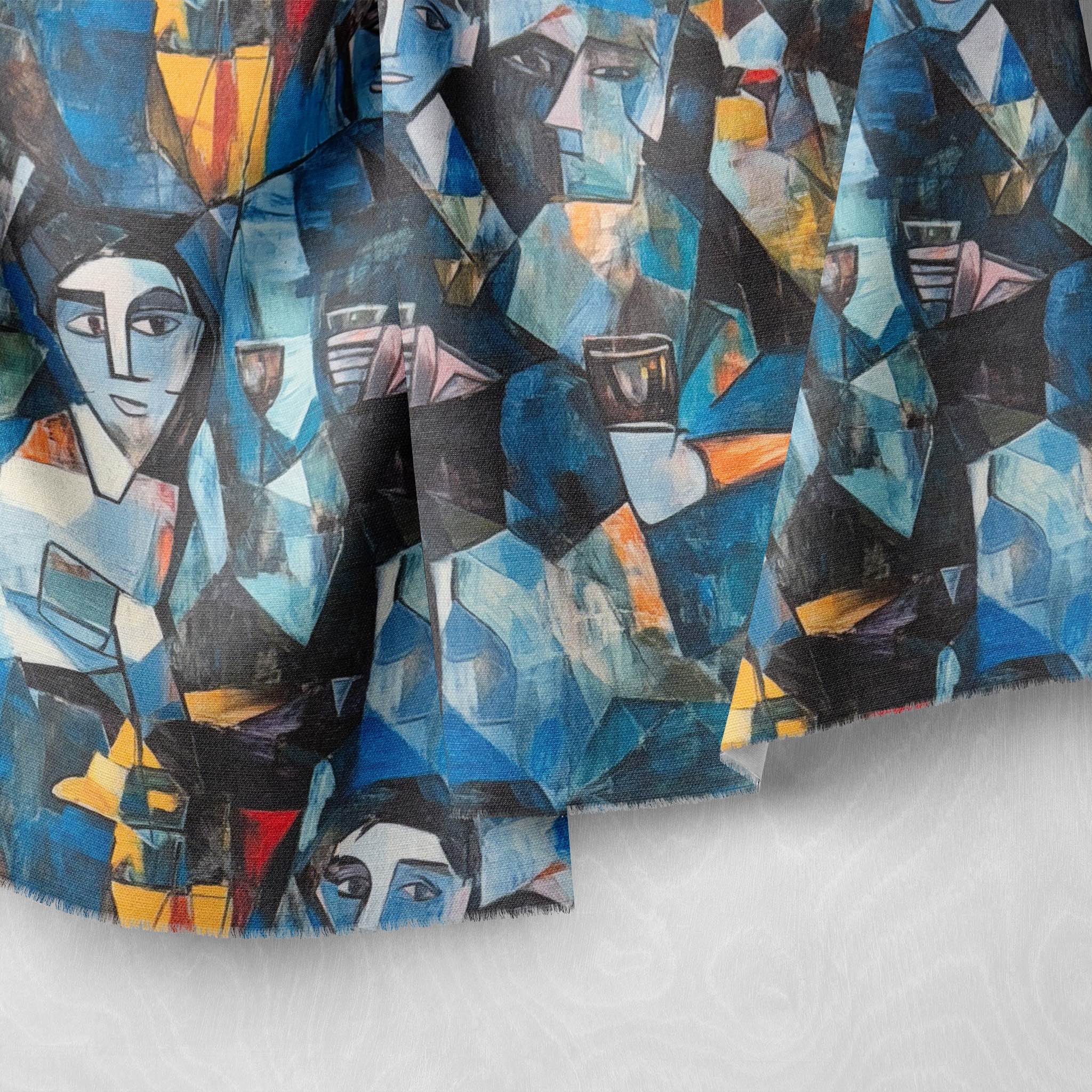 Detail of painterly blue fabric showing abstract brushstrokes and stylised faces