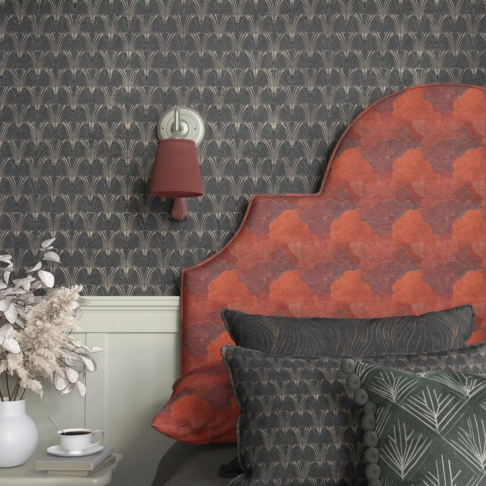 Art Nouveau upholstery fabric headboard in red with large-scale floral pattern and gold line detailing in a warm styled bedroom