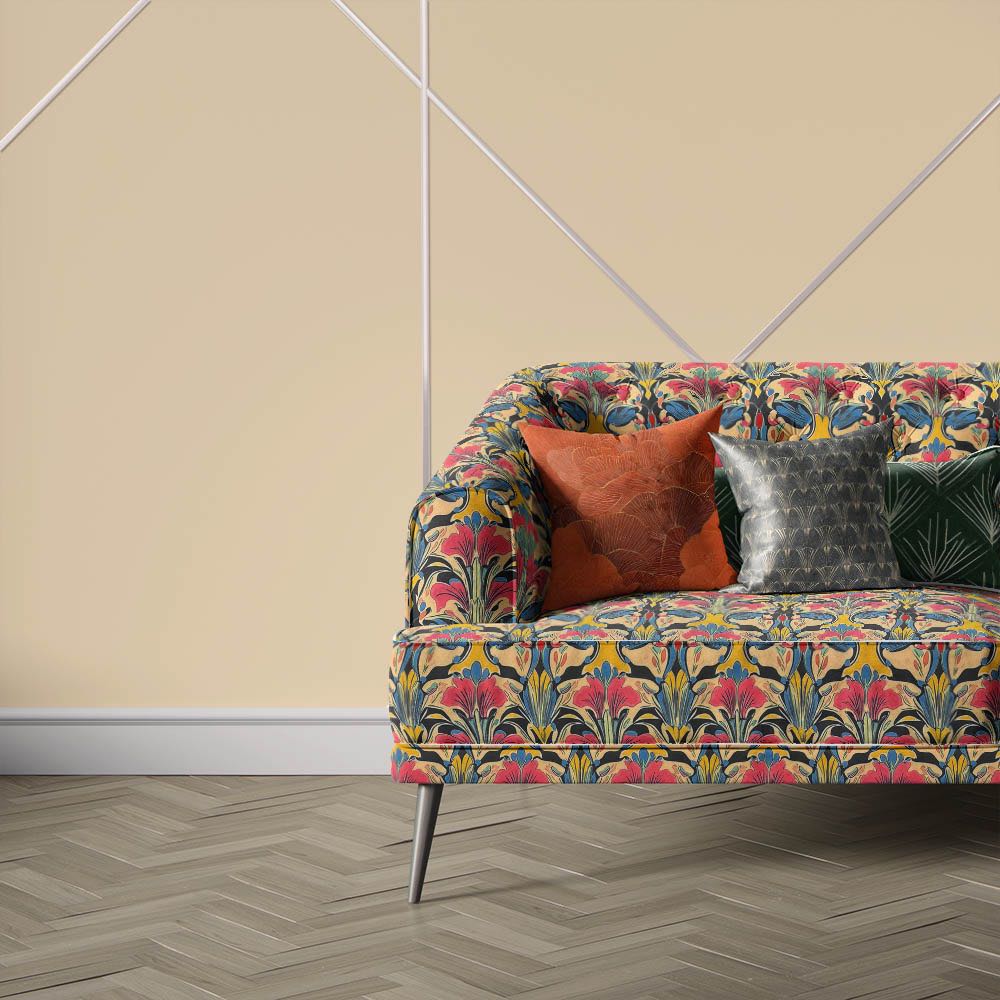 Nouveau Velvet No.5 printed velvet fabric upholstered on sofa featuring colourful Art Nouveau floral pattern in coral pink, gold, navy and black tones