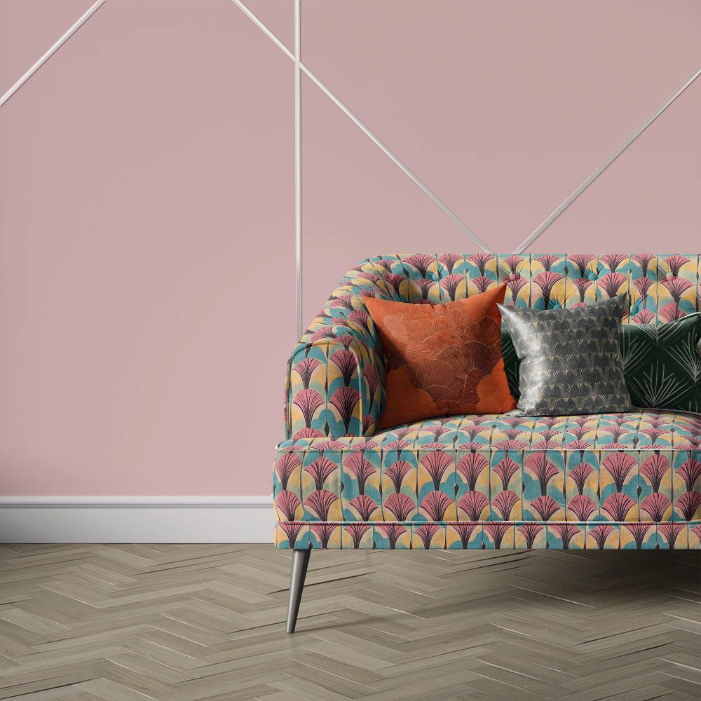 Nouveau Velvet No.6 printed velvet fabric upholstered on sofa featuring repeating Art Deco fan pattern in pink, teal and cream tones