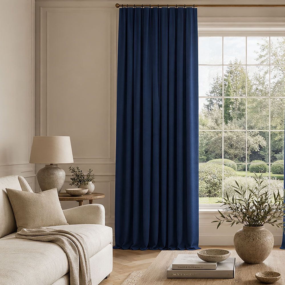 Palermo Coastal Fjord blue curtain fabric showcasing a rich plain weave texture and graceful full-length folds in a refined living room