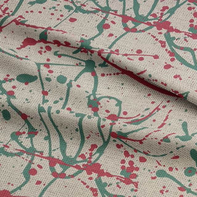 Close-up of artistic abstract fabric showing pink and green splatter details